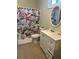 Bathroom featuring a vanity with white cabinets, a toilet, and a shower with a floral curtain at 2245 Panstone Sw Dr, Marietta, GA 30060