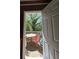 An open doorway leads to a rustic backyard patio with a table and chairs for outdoor dining at 2245 Panstone Sw Dr, Marietta, GA 30060