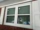 A window with white frame and trim and functioning shutters on a brick exterior home at 2245 Panstone Sw Dr, Marietta, GA 30060