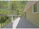 Back deck overlooking yard and trees with a metal railing and sliding doors that lead into the house at 115 Beechwood Trl, Roswell, GA 30075