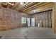 Unfinished basement framed and insulated, with exposed ceiling rafters, concrete floor and a small window at 115 Beechwood Trl, Roswell, GA 30075