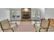 Tile-floored basement showcasing a cozy fireplace and comfortable seating, offering a relaxing retreat at 115 Beechwood Trl, Roswell, GA 30075