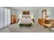 Spacious bedroom boasts carpet floors, soft natural light, and dresser furniture for added comfort at 115 Beechwood Trl, Roswell, GA 30075