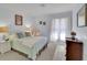 Cozy bedroom featuring carpet floors, complemented by natural light streaming through the window at 115 Beechwood Trl, Roswell, GA 30075