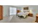Bright bedroom with carpet, features a bed, dresser, and nightstands for a comfortable retreat at 115 Beechwood Trl, Roswell, GA 30075