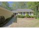 This home features classic black shutters, a well-manicured lawn, and a walkway leading to the inviting front entrance at 115 Beechwood Trl, Roswell, GA 30075