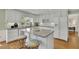 Bright kitchen features white cabinetry, stainless steel appliances, granite counters, and a central island with seating at 115 Beechwood Trl, Roswell, GA 30075