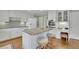 Bright kitchen with a center island, granite countertops, stainless oven, and white cabinetry at 115 Beechwood Trl, Roswell, GA 30075