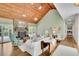 Bright living room with hardwood floors, vaulted wood ceiling, stone fireplace, and sliding doors to the outdoor space at 115 Beechwood Trl, Roswell, GA 30075