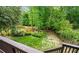 Spacious backyard featuring a lush lawn and bordered by mature trees and a wooden fence at 1270 Cameron Crk, Marietta, GA 30062