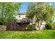 Back exterior view featuring a deck, stairs, and a well-maintained lawn with mature trees at 1270 Cameron Crk, Marietta, GA 30062