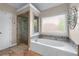 Elegant bathroom with a soaking tub, glass shower, and decorative tile accents at 1270 Cameron Crk, Marietta, GA 30062