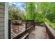 Outdoor deck area with wooden floors, a table with chairs, and a lush green surrounding at 1270 Cameron Crk, Marietta, GA 30062
