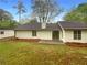 Backyard view of a single story home, showcasing the yard and exterior siding at 2424 Turtle Xing Ne, Marietta, GA 30066
