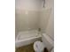 Full bath featuring a standard white bathtub and toilet, with tiled walls around the tub area at 2424 Turtle Xing Ne, Marietta, GA 30066