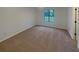 Clean, carpeted bedroom with a window offering natural light; simple yet inviting at 2424 Turtle Xing Ne, Marietta, GA 30066