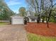 Charming single-story home with a well-maintained lawn, mature trees, and a driveway leading to an attached garage at 2424 Turtle Xing Ne, Marietta, GA 30066