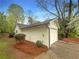 Side view of detached garage with white siding and landscaping at 2424 Turtle Xing Ne, Marietta, GA 30066