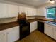 Kitchen area featuring ample counter space, white cabinets, and contemporary appliances at 2424 Turtle Xing Ne, Marietta, GA 30066