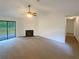 Inviting living room featuring a fireplace, neutral carpet, and sliding glass doors to the outdoor area at 2424 Turtle Xing Ne, Marietta, GA 30066