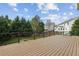 Expansive back deck with black metal railings overlooking a lush yard and neighborhood at 3465 Caney Creek Ln, Cumming, GA 30041