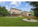 Spacious backyard features a concrete patio, a fire pit, and plenty of green space at 3465 Caney Creek Ln, Cumming, GA 30041