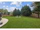 Lush backyard features an in-ground fire pit and mature trees bordering the property at 3465 Caney Creek Ln, Cumming, GA 30041