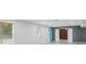 Basement with natural light and open floor plan, featuring modern white walls and wood accent wall at 3465 Caney Creek Ln, Cumming, GA 30041