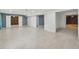 Spacious basement with tile flooring, neutral walls, and wood accent wall at 3465 Caney Creek Ln, Cumming, GA 30041