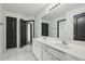 Bathroom featuring double sinks, white tile flooring, and a large mirror at 3465 Caney Creek Ln, Cumming, GA 30041