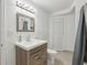 Bright bathroom features a single sink vanity, square mirror, and modern light fixture at 3465 Caney Creek Ln, Cumming, GA 30041