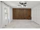 Bedroom featuring a wood accent wall, bright window, and tile flooring at 3465 Caney Creek Ln, Cumming, GA 30041