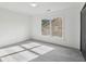 Bright bedroom with natural light from the window and plush gray carpeting at 3465 Caney Creek Ln, Cumming, GA 30041