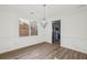 Elegant dining room featuring hardwood floors, wainscoting, modern lighting, and a view into the kitchen at 3465 Caney Creek Ln, Cumming, GA 30041