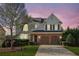Charming two-story home featuring a brick facade, attached two-car garage, landscaped front yard, and a welcoming entrance at 3465 Caney Creek Ln, Cumming, GA 30041