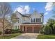 Charming two-story home featuring a brick facade, attached two-car garage, landscaped front yard, and a welcoming entrance at 3465 Caney Creek Ln, Cumming, GA 30041