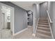 Hallway with gray walls, open shelves, and tile flooring at 3465 Caney Creek Ln, Cumming, GA 30041