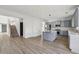Open layout with kitchen island, stainless steel appliances and staircase access at 3465 Caney Creek Ln, Cumming, GA 30041