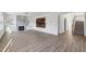 Spacious living room with fireplace, custom accent wall, and open access to stairs at 3465 Caney Creek Ln, Cumming, GA 30041