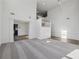 Bright, open-concept living room with soaring ceilings, large windows, and neutral carpet at 3465 Caney Creek Ln, Cumming, GA 30041