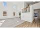 Bright, open-concept living room with soaring ceilings, large windows, neutral carpet, and hardwood flooring at 3465 Caney Creek Ln, Cumming, GA 30041