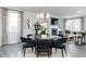 Elegant dining area with a round glass table, black velvet chairs, and modern chandelier at 2719 Stream Valley Nw Ln, Atlanta, GA 30318