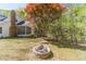 Backyard with brick fire pit, mature trees, and a screened-in porch for outdoor relaxation at 3775 Belle Glade Trl, Snellville, GA 30039