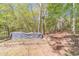 View of a large area of a wooded backyard with tree trunks cut to equal height creating the edge of a path at 3775 Belle Glade Trl, Snellville, GA 30039