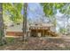 Expansive backyard featuring a large wooden deck, brick foundation, and mature trees at 3775 Belle Glade Trl, Snellville, GA 30039