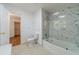Stylish bathroom with a marble-look tiled shower and glass door and tiled floors at 3775 Belle Glade Trl, Snellville, GA 30039
