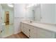 Bright bathroom featuring an extended vanity, plenty of storage and a door leading to a walk-in closet at 3775 Belle Glade Trl, Snellville, GA 30039