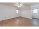 Spacious bedroom with wood floors, neutral walls, ceiling fan, and natural light from two windows at 3775 Belle Glade Trl, Snellville, GA 30039
