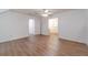 Bedroom featuring wood floors, white walls, a ceiling fan, and doorway leading to the walk-in closet at 3775 Belle Glade Trl, Snellville, GA 30039