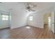Bedroom with wood floors, neutral walls, multiple windows, and doorway leading to the bathroom at 3775 Belle Glade Trl, Snellville, GA 30039